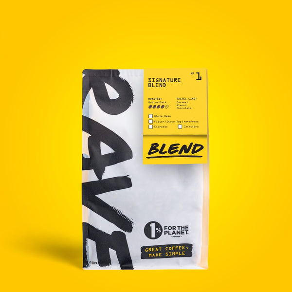 Coffee package with '1% for the Plane' branding on a yellow background