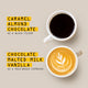Two coffee cups, one with dark coffee and the other with a latte art design, on a beige background.