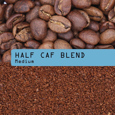 Coffee photograph showing whole roasted coffee beans at the top, roasted coffee grounds at the bottom, and a pastel blue label across the center reading “Half caf blend” and “Medium”.