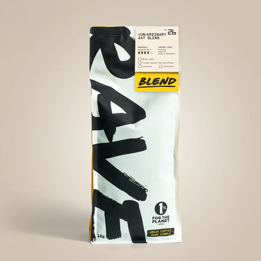 1kg bag of coffee with visible (Un)ordinary and Rave branding on a beige background.