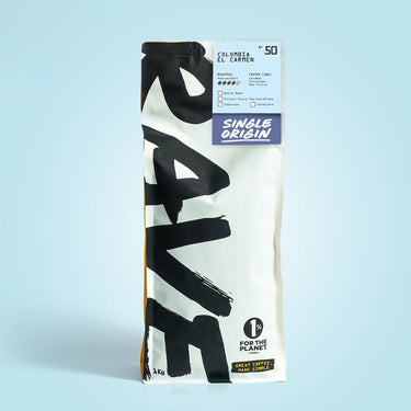 1kg Coffee bag labeled 'Colombia El Carmen' with Rave branding and text on a light blue background