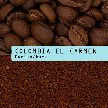 Coffee product photo showing whole roasted coffee beans at the top, ground coffee at the bottom, and a light blue label across the center reading 'COLOMBIA EL CARMEN Medium/Dark'.