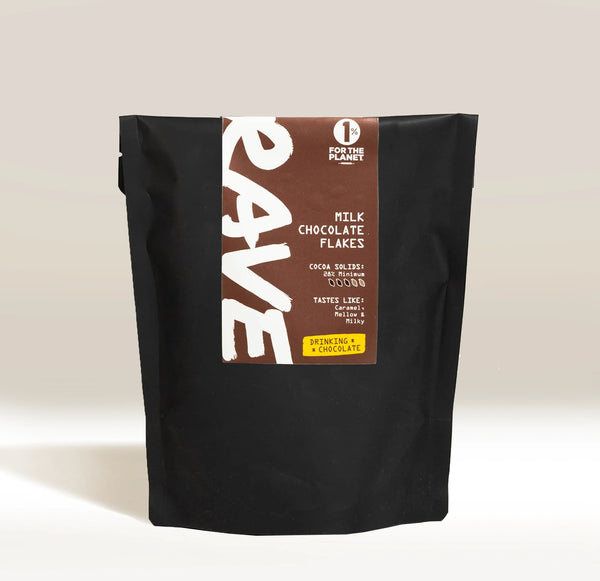 Black bag of Rave milk chocolate flakes with a brown label on a light beige background